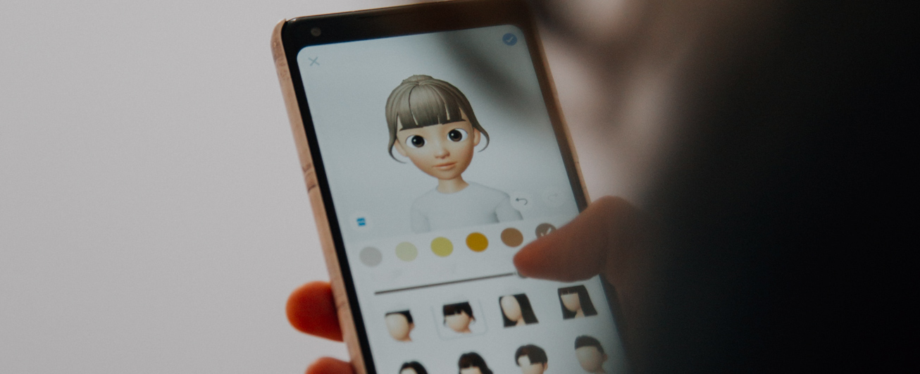 Person customising their avatar on mobile phone
