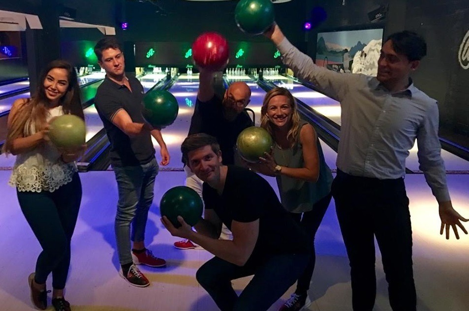 Wealth Dynamix employees enjoying bowling on a business social event